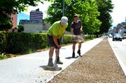 Manuel Hefti (links) und Tobias Mäder (Gärtnerei Messmer AG, Berneck) säen die Magerwiese entlang der Bahnstrasse auf einer Strecke von knapp dreihundert Metern an. (Bild: Monika von der Linden)