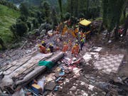 Nach dem Einsturz eines vierstöckigen Gebäudes im indischen Bundesstaat Himachal Pradesh suchen Rettungskräfte nach Verschütteten. Zwölf Menschen konnten bisher nur tot geborgen werden. (Bild: KEYSTONE/AP)