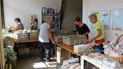 Die ehrenamtlichen Helferinnen richten die Lebensmittel unter der Anleitung von Gabi Mauchle (3. von links) für die Abgabe schön her. (Bild: Marco Enzler)
