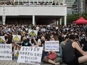 Mit Gesichtsmaske an der Demonstration: Staatsbedienstete auf der Strasse in Hongkong. (Bild: KEYSTONE/EPA/JEROME FAVRE)