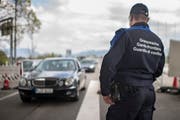 Ein Zöllner am Grenzübergang zwischen Österreich und der Schweiz beobachtet den Verkehr beim Grenzübertritt in die Schweiz. (Bild: Benjamin Manser)