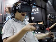 Vom neuen ultraschnellen Mobilfunknetz der 5. Generation sollen auch Online-Gamer profitieren. (Bild: KEYSTONE/AP/EUGENE HOSHIKO)