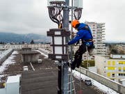 Ein Techniker installiert im April dieses Jahres auf einem Genfer Gebäude eine 5G-Antenne. (Bild: KEYSTONE/LEANDRE DUGGAN)