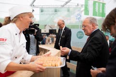 Johann Schneider-Ammann gönnt sich eine kleine Stärkung an einem Degustationsstand. (Bild: Keystone)