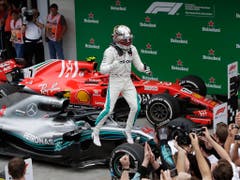 Hamilton springt jubelnd von seinem Mercedes-Dienstfahrzeug (Bild: KEYSTONE/AP/ANDRE PENNER)