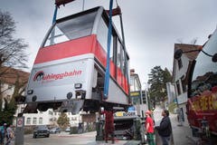 Etwas Nostalgie für eingefleischte Fans des Mühleggbähnli: Die alte Bahnkabine wurde Anfang April 2018 von den Schienen gehoben und abtransportiert. Mit der neuen Kabine hat nicht nur die Bemalung geändert, die Bahn benutzt auch ein neues Logo. (Bild: Ralph Ribi - 3. April 2018)