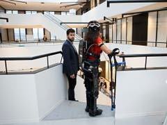 Ein Helfer bleibt in der Nähe, um gegebenenfalls mit dem Exoskelett zu assistieren. Besondere Fachkenntnisse müsse ein solcher Begleiter aber nicht haben, so die EPFL-Forscher. (Bild: KEYSTONE/SALVATORE DI NOLFI)