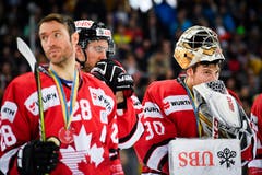 Enttäuschte Spieler des Team Canada: Dominic Moore (links) und Torhüter Zachary Fucale. Bild: Gian Ehrenzeller / Keystone (Davos, 31.12.2018)