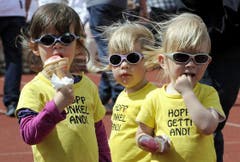 Elina, Sara und Leone (von links) geniessen die Glace und feuern Vorjahressieger Andi Imhof an. (Bild: Keystone)