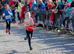 kinder und Erwachsene laufen durch die Zuger Altstadt, beobachtet von Hunderten Zuschauern. (Bild: Stefan Kaiser (Zuger Zeitung))