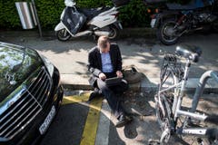 Ein Journalist arbeitet vor dem Fünfstern-Hotel Baur au Lac in Zürich. (Bild: EPA)