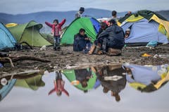 Aufgrund der Regenfälle haben sich in Idomeni Pfützen gebildet und der Boden ist schlammig. Viele Flüchtlinge haben ihre Zelte abgebrochen und auf trockeneren Flecken wieder aufgebaut. (Bild: Keystone)
