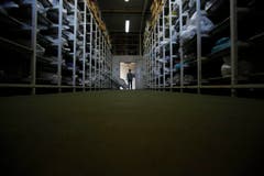 Dieses Foto vom 20. März zeigt einen Forensiker in einer Halle, in der die menschlichen Überreste von mehr als 4500 Personen eingelagert sind, die noch nicht identifiziert werden konnten. (Bild: AP Photo / Amel Emric)
