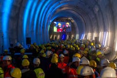 Bauarbeiter verfolgen den erfolgreichen Durchstoss der Weströhre am Ceneri-Basistunnel. (Bild: Keystone)