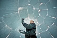 Iglubauer Lukas Zogg füllt noch die grössten Zwischenräume seiner Schneekuppel aus. (Bild: Pius Amrein / Neue LZ)