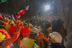 Bauarbeiter feiern den erfolgreichen Durchstoss der Weströhre am Ceneri-Basistunnel. (Bild: Keystone)