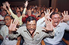 Mitglieder eines Lachclubs schneiden Grimassen während einer Lachveranstaltung in Bangalore, am 23. Dezember 2001. Die meisten der 900 Teilnehmer sind überzeugt, dass Lachen gut für ihre Gesundheit ist. (Bild: Keystone)