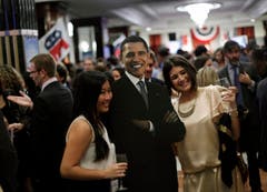 Leute posieren mit einer Pappfigur von Barack Obama. (Bild: Keystone)