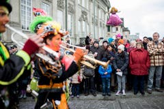 Zuschauer beobachten kostümierte Personen die Trompete spielen und am Umzug "ZüriCarneval 2015" teilnehmen. (Bild: ENNIO LEANZA)