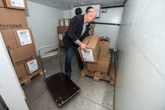 Bei minus 30 Grad schockgefroren: Docusave-Inhaber Guido Voser bringt beschädigte und nasse Bestände in den Kühlraum. (Bild: Urs Lindt)