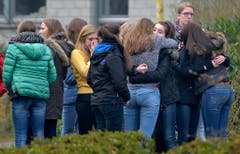 Gymnasiasten versammeln sich vor der Schule, um miteinander zu trauern. (Bild: Keystone)
