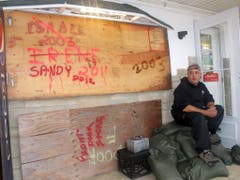 Nicht der erste Tropensturm: Auf der Bretterwand vor einem Fischergeschäft in Point Pleasant Beach sind die Namen der letzten Wirbelstürme verewigt. (Bild: Keystone)