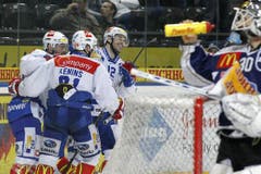 Der Zuger Goalie Jussi Markkanen, rechts, trinkt, während die Zürcher jubeln. (Bild: Keystone)