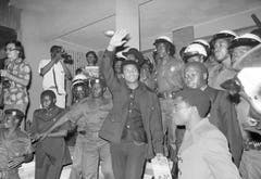 Muhammad Ali, umgeben von Soldaten, winkt in den Menschen zu, welche ihn in Kinshasa empfangen. (Bild: Keystone)