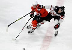 Switzerland's Kevin Fiala, left, challenges for the puck with Canada's Pierre-Luc Dubois during the Ice Hockey World Championships semifinal match between Canada and Switzerland at the Royal arena in Herning, Denmark, Saturday, May 19, 2018. (AP Photo/Petr David Josek)