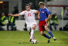 Switzerland's Xherdan Shaqiri, left, fights for the ball with Liechtenstein's Martin Rechsteiner during a friendly soccer match between Liechtenstein and Switzerland at the Rheinpark Stadium in Vaduz, Liechtenstein, Wednesday, August 10, 2011. (KEYSTONE/Peter Klaunzer)