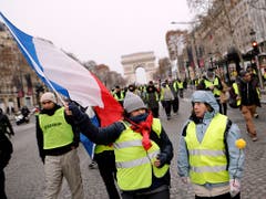 Gelbwesten beim Triumphbogen in Paris: Vor allem asiatische Touristen meiden die französische Hauptstadt im Moment wegen der Unruhen. (Bild: KEYSTONE/AP/KAMIL ZIHNIOGLU)