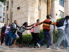 Zahlreiche Menschen werden aus einem Luxushotel in Nairobi geleitet, nachdem auf das Gebäude ein Anschlag verübt worden war. (Bild: KEYSTONE/EPA/DAI KUROKAWA)