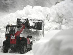 Ein Bagger befreit am Mittwoch eine Strasse in Niedertauern (Salzburg) von den Schneemassen.ER) (Bild: Keystone/APA/APA/HARALD SCHNEIDER)