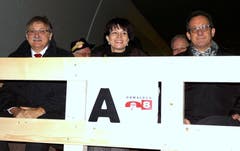 An der Eröffnung des A8-Tunnels in Lungern (von links): Landammann Franz Enderli , Bundesrätin Doris Leuthard und Baudirektor Paul Federer fahren auf dem Tiefladewagen zum Lichtspektakel in den neuen Tunnel. (Bild: Romano Cuonz, 10. Dezember 2012)