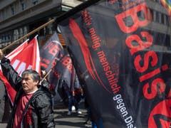 Die Oppositionsgruppe «Basis 21» nutzte die 1. Mai-Demonstration in Basel, um Kritik an der Unia-Leitung zu äussern. Rund 100 Personen schlossen sich der Gruppe an und stellten sich dem Demonstrationszug kurzzeitig in den Weg, um an der Mittleren Brücke ein Transparent zu befestigen. (Bild: KEYSTONE/GEORGIOS KEFALAS)