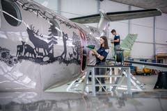 Chiara Christen ist Lernende bei Pilatus. Sie hat den Scherenschnitt von Paul Waser mit anderen Mitarbeitenden am Flugzeug montiert. (Bild: Pius Amrein, Stans, 2. Mai 2019)