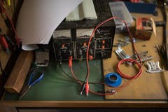 Die Werkbank hat er aus drei alten Schreibtischen improvisiert. Darauf liegen Bauteile, eine Zange und Schrauben. (Bild: Benjamin Manser)