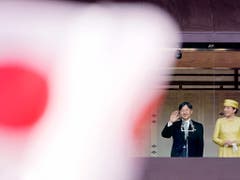 Winken vom Palastbalkon: Japans Kaiser Naruhito und Kaiserin Masako begrüssen Gratulanten beim ersten öffentlichen Auftritt im Amt. (Bild: KEYSTONE/EPA/FRANCK ROBICHON)