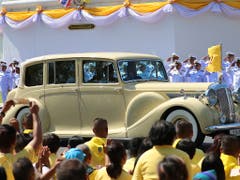 Anfahrt im Rolls Royce: Thailands Königspaar auf dem Weg zur Krönung. (Bild: KEYSTONE/AP/SAKCHAI LALIT)