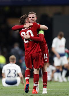 Liverpool's Adam Lallana, left and Jordan Henderson celebrate at the end of the Champions League final soccer match between Tottenham Hotspur and Liverpool at the Wanda Metropolitano Stadium in Madrid, Saturday, June 1, 2019. (AP Photo/Bernat Armangue)