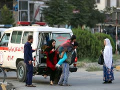 Ein Mann trägt ein verletztes Mädchen. bei den Angriff auf das Büro eines Kandidaten in Kabul ist mindestens ein Mensch getötet worden. (Bild: KEYSTONE/EPA/JAWAD JALALI)