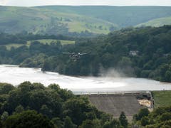 Das um 1830 gebaute Reservoir enthält rund 1,3 Millionen Tonnen Wasser. Ein Lasten-Helikopter warf grosse Säcke mit einer Mischung aus Sand, Kies und Schotter ab, um die Mauer des Reservoirs zu stabilisieren. (Bild: KEYSTONE/AP/JON SUPER)